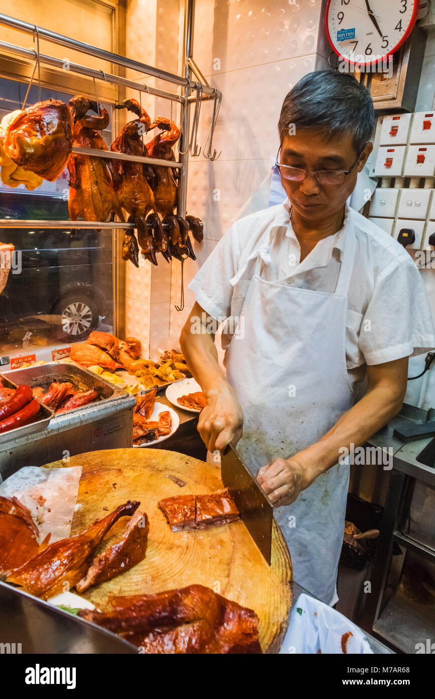 China, Hong Kong, Chef Chopping Roast Duck Stock Photo