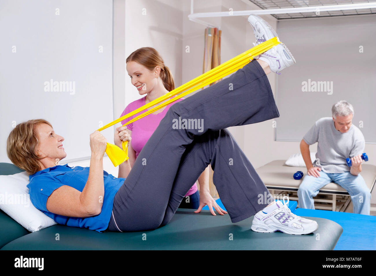 Physiotherapist assisting a patient in exercising Stock Photo