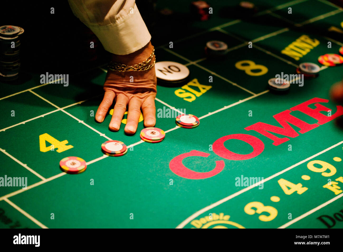 High angle view of a man's hand on a gaming table in a casino, Las Vegas, Nevada, USA Stock Photo