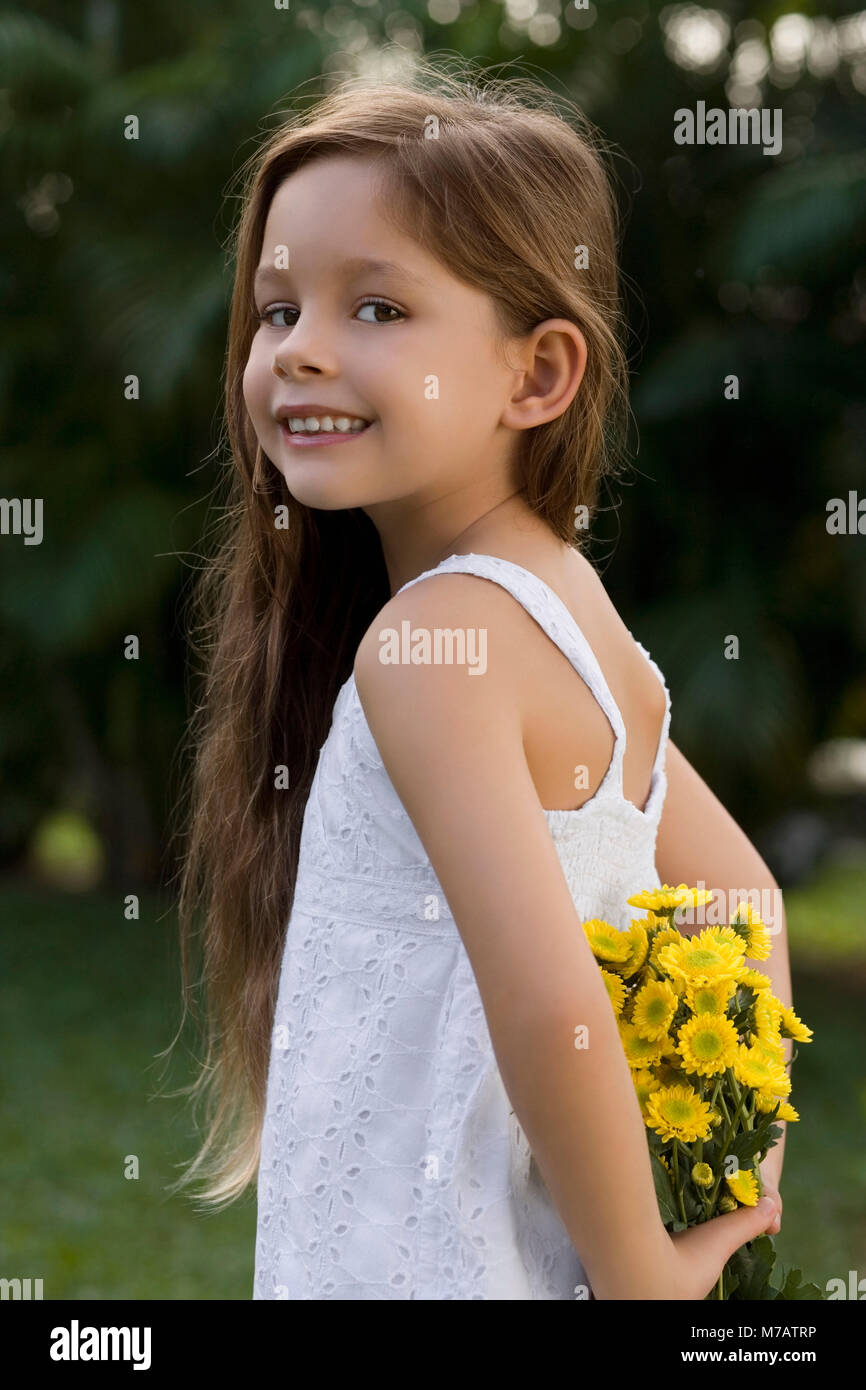Portrait of a girl holding a bunch of flowers and smiling Stock Photo ...