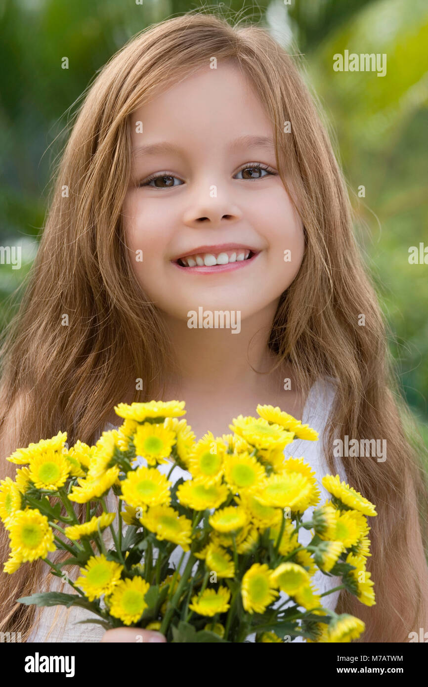 Portrait of a girl holding a bunch of flowers and smiling Stock Photo ...