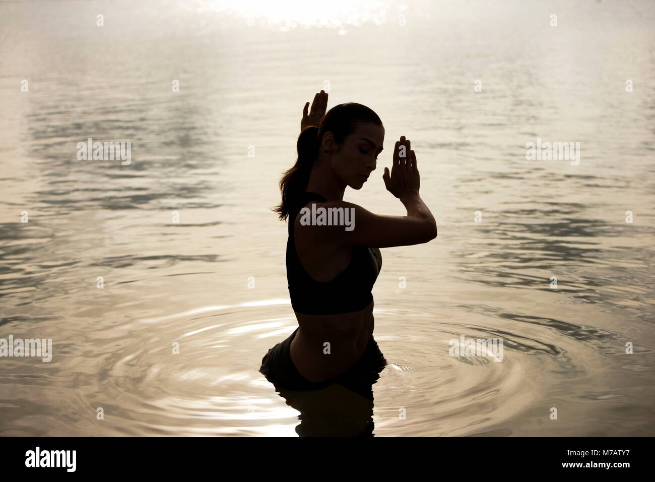 High angle view of a young woman exercising in a lake Stock Photo