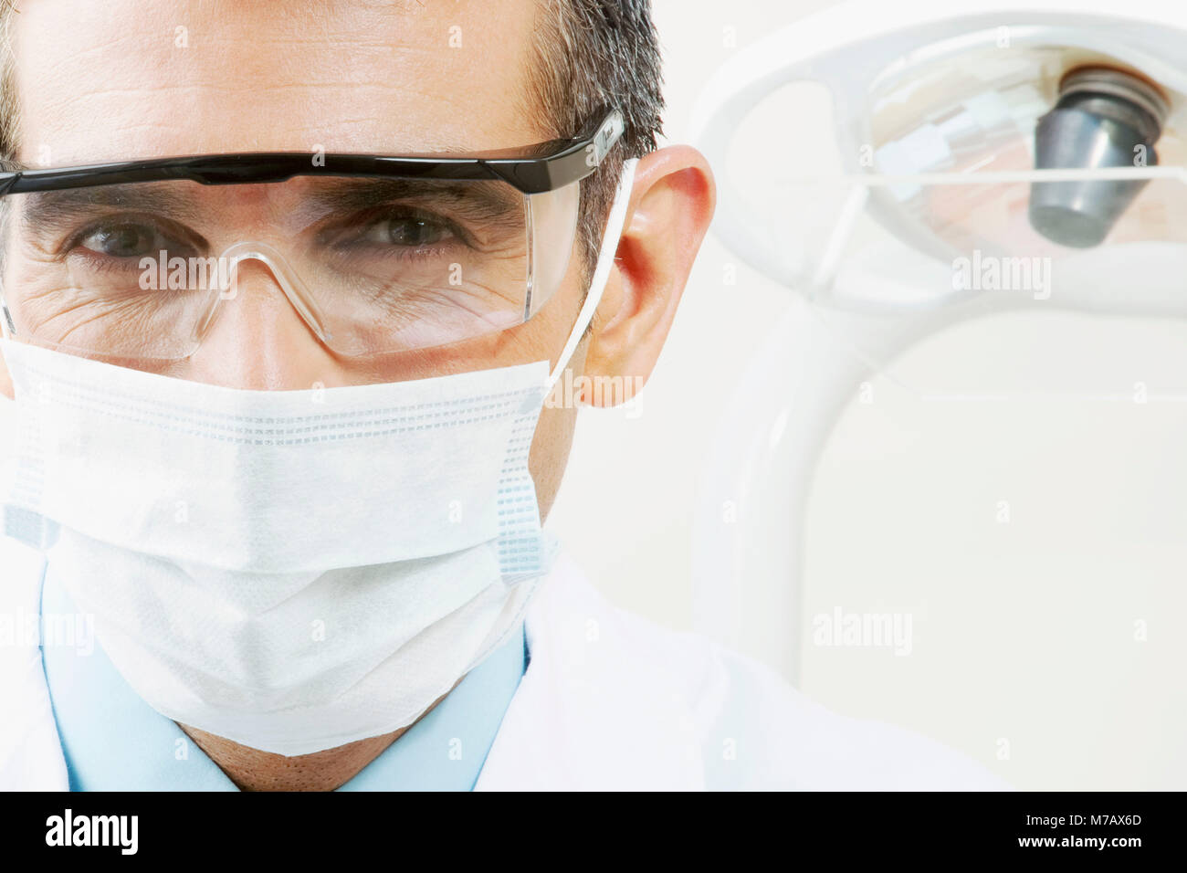Portrait of a dentist wearing a surgical mask Stock Photo Alamy