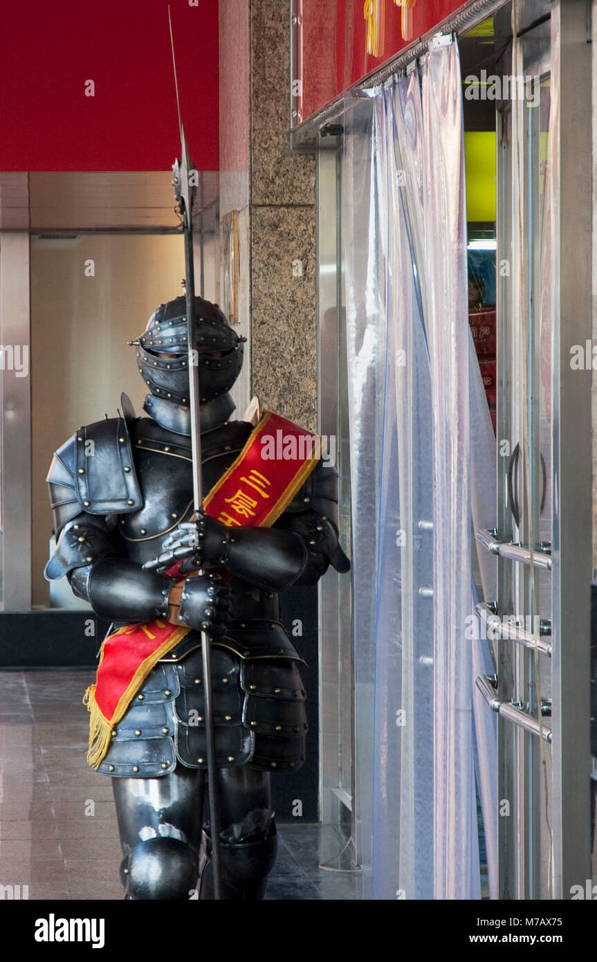 Statue of chinese warrior in front of a store hires stock photography