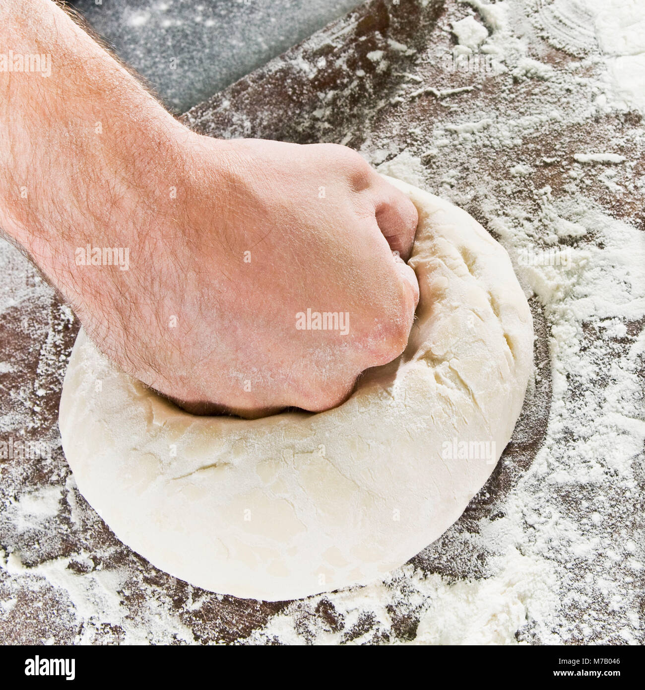 Chef kneading pizza dough Stock Photo - Alamy