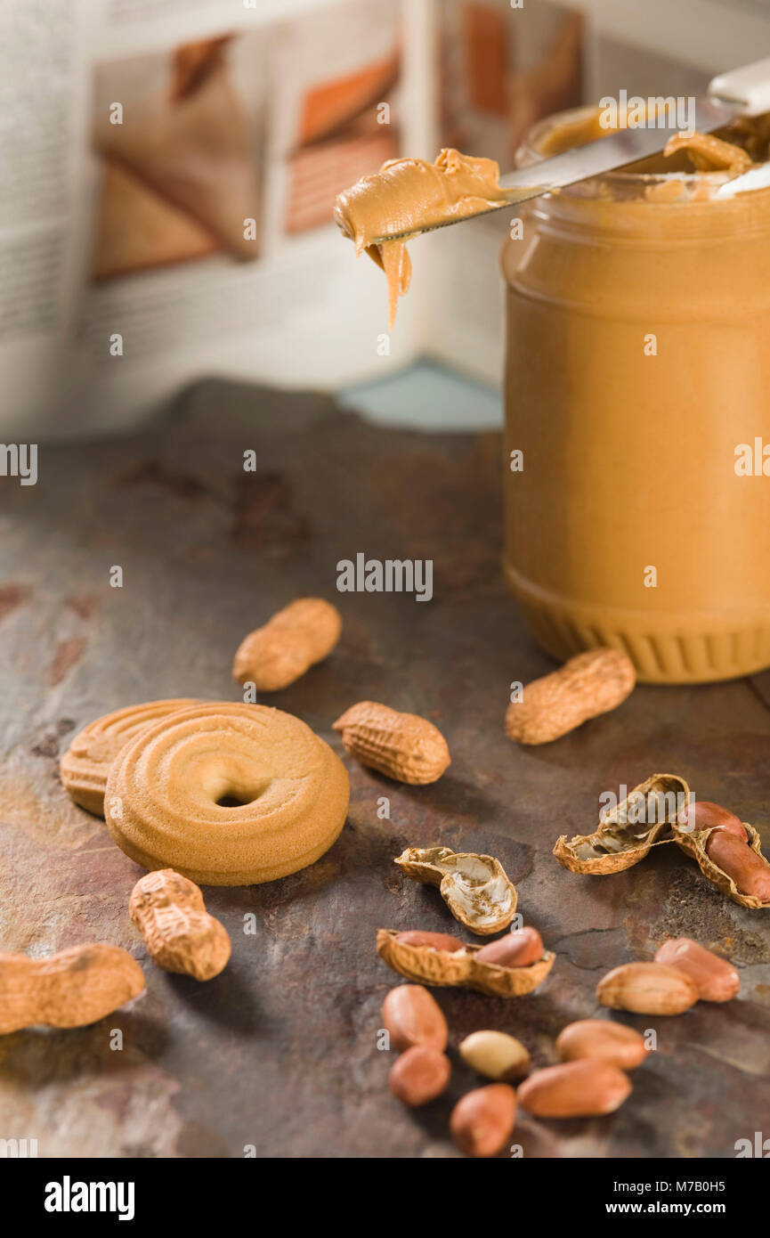Close up of peanut butter with peanuts and cookies hires stock