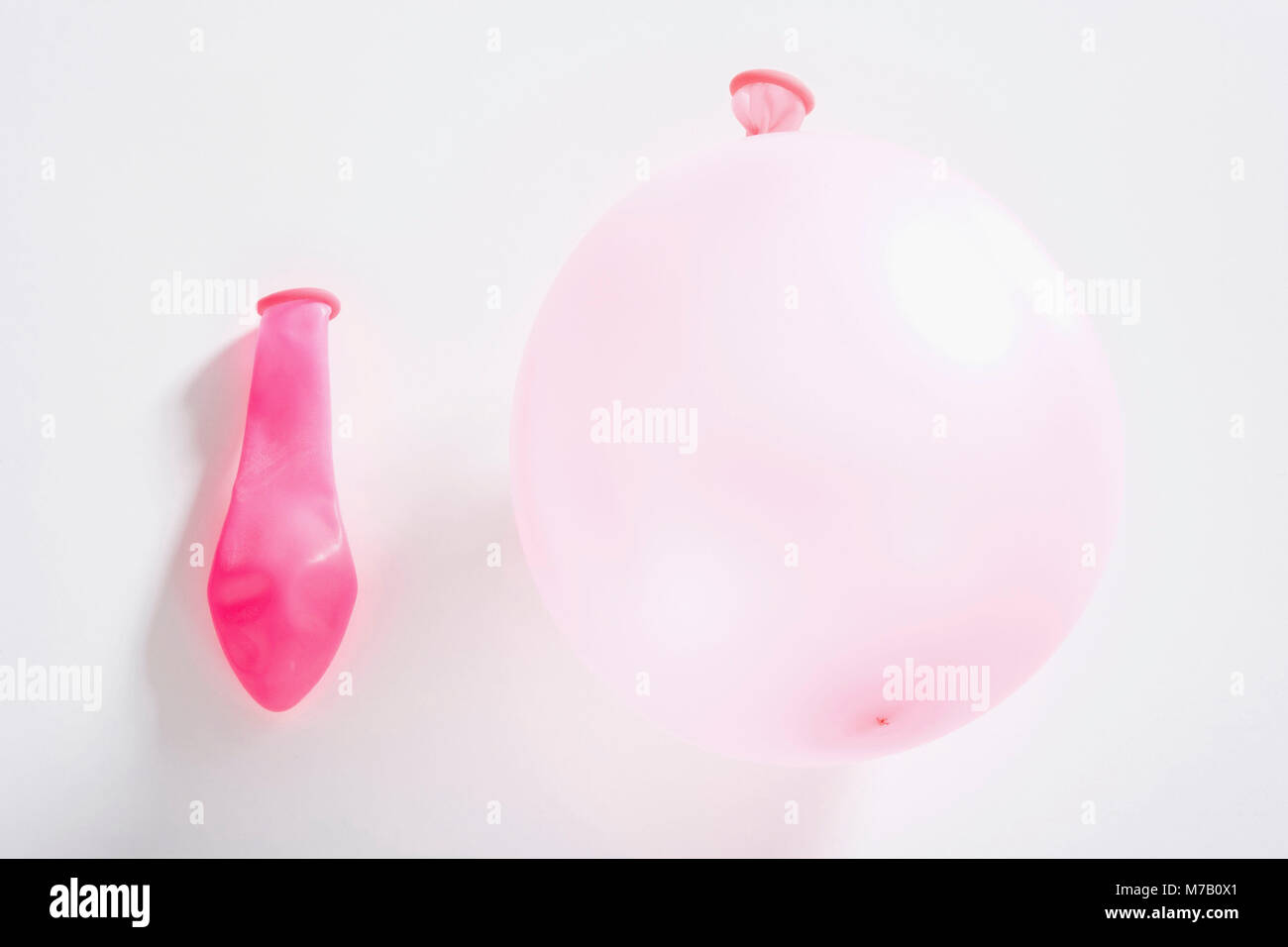Close-up of a balloon with a deflated balloon Stock Photo