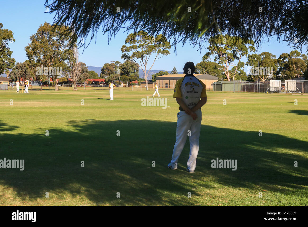 Adelaide Australia 10th March 2018. A Cricket player stands in the shade  during a local cricket match  on a hot summer day in Adelaide  as temperatures reach 37 degrees celsius Credit: amer ghazzal/Alamy Live News Stock Photo