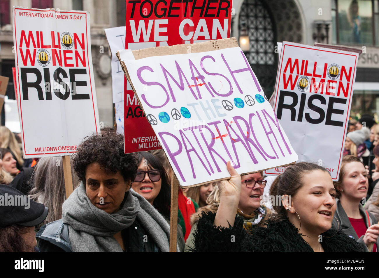 London, UK. 10th March, 2018. A woman holds a placard reading 'Smash the patriarchy on the annual Million Women Rise march through central London against male violence in all its forms. The march takes place on the nearest Saturday to International Women's Day. Credit: Mark Kerrison/Alamy Live News Stock Photo
