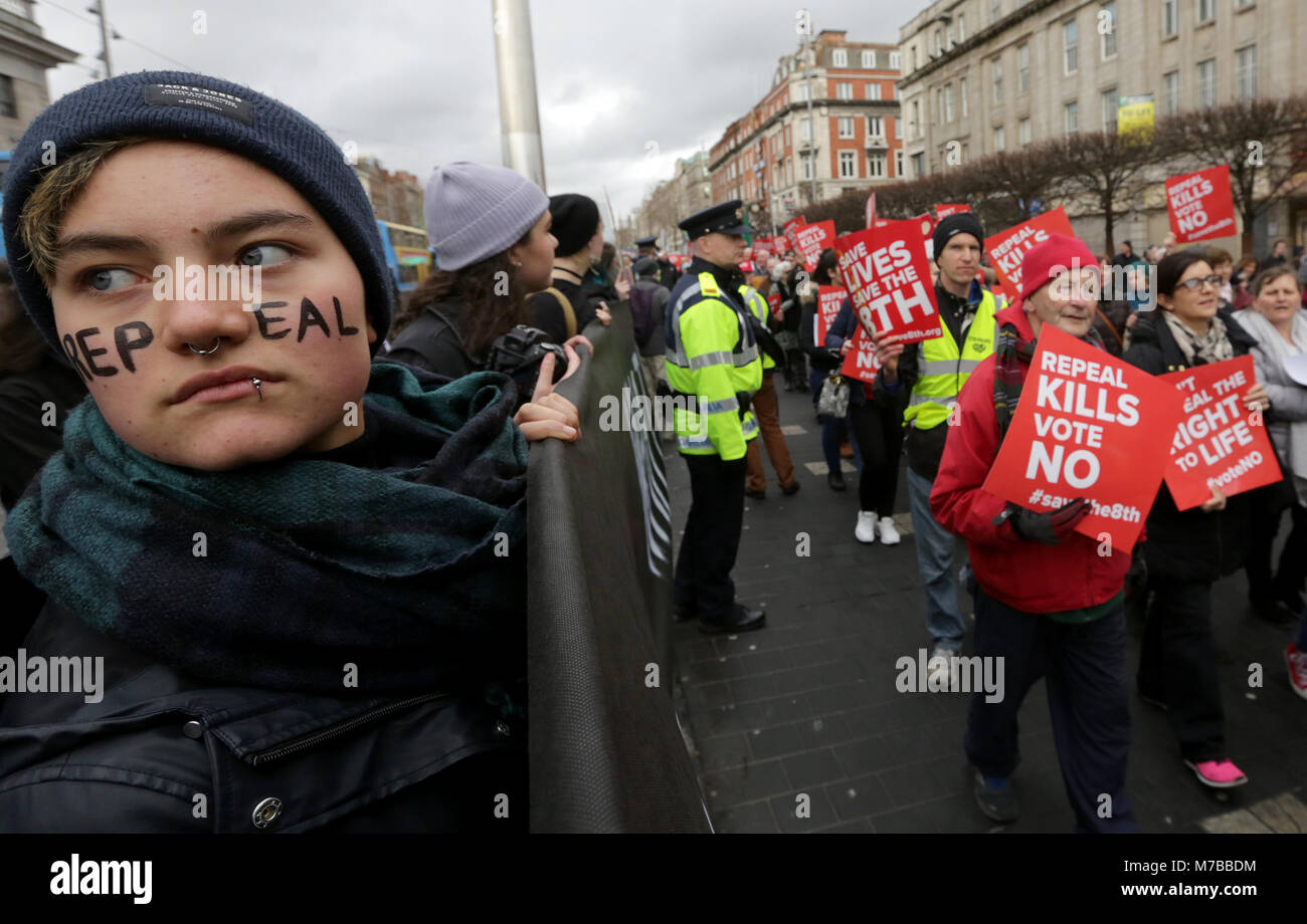 Dublin, Ireland. 10th March 2018. Pro-choice campaigners who want to ‘Repeal the Eighth’ amendment hold a silent protest as those who want to ‘Save the Eighth’ pass by on O’connell Street in Dublin City centre. The eighth amendment to the Irish constitution equates, in law, the right to life of the unborn with the right to life of the mother. Ireland is due to hold a referendum on abortion this coming May. Credit : Laura Hutton/Alamy Live News. Stock Photo