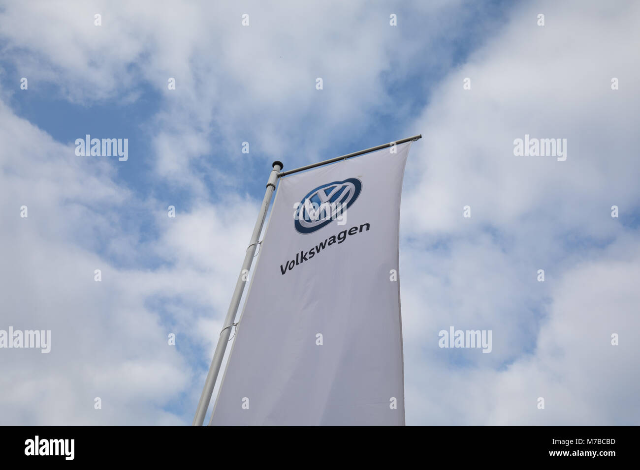 09 March 2018, Germany, Emden: The Volkswagen logo is printed on a banner outside the Volkswagen plant Emden. The Group Management Board will be revealing the results of the 2017 business year at the annual press conference of the Volkswagen Group on 13 March 2018. Photo: Jörg Sarbach/dpa Stock Photo