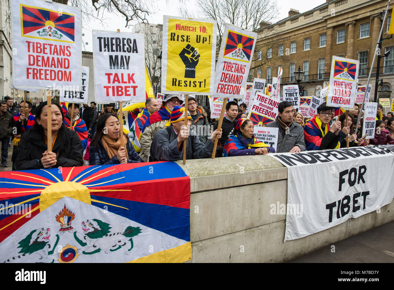 London, UK. 10th March, 2018. Members of the UK's Tibetan community attend the annual Uprising Day rally opposite Downing Street prior to a march to the Chinese embassy. Tibetan Uprising Day, observed on 10th March,  commemorates the 1959 Tibetan uprising against the presence of the People's Republic of China in Tibet. It resulted in a violent crackdown on Tibetan independence movements and the flight of the Dalai Lama into exile. Credit: Mark Kerrison/Alamy Live News Stock Photo