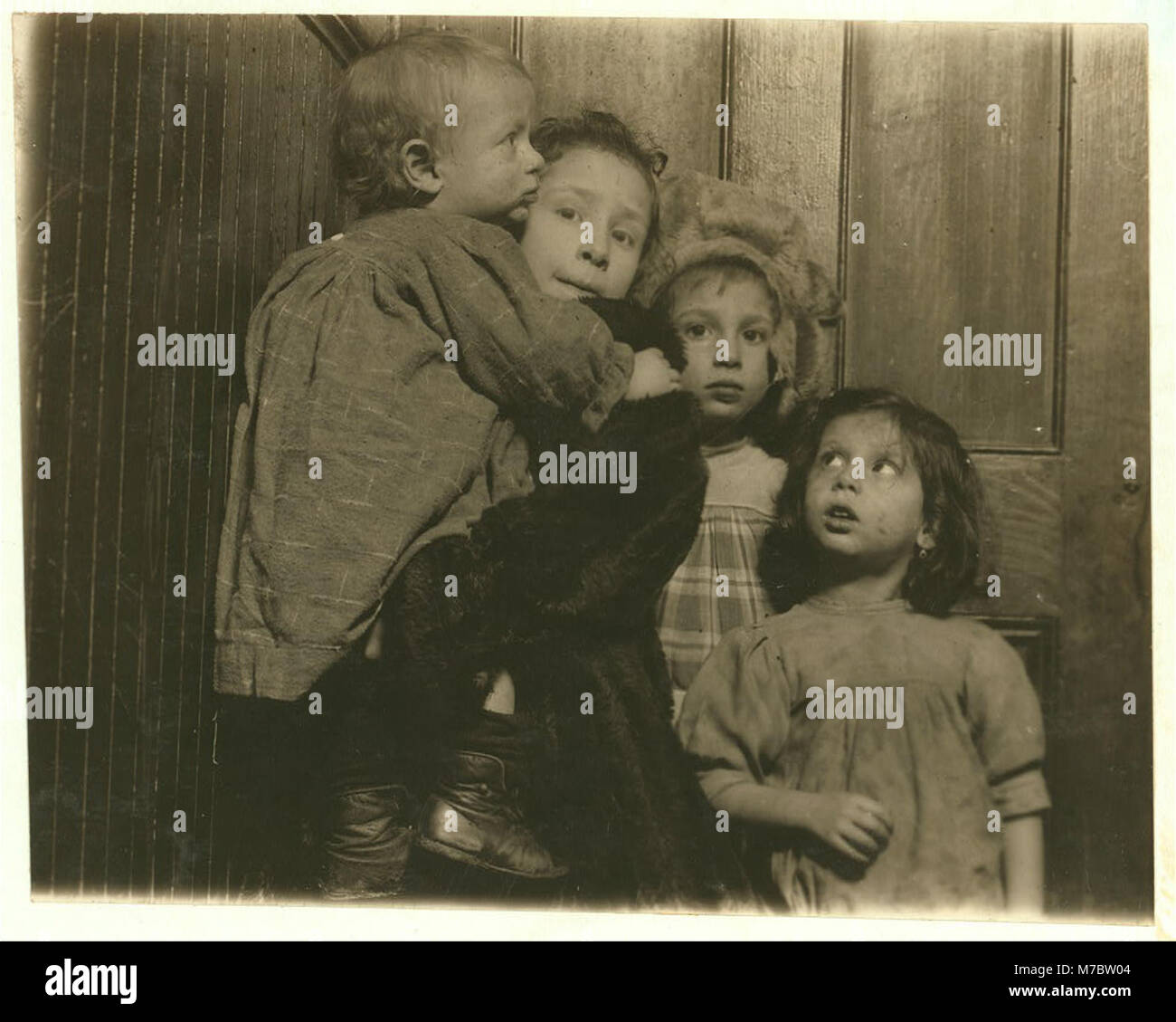 3-30 P.M. Group in tenement hallway. Ages, 14 months, 2, 5, and 7 years. Mother in shop sewing. Father out of work, bartender. Family, Novi, 189 Chrystie Street. LOC nclc.04628 Stock Photo