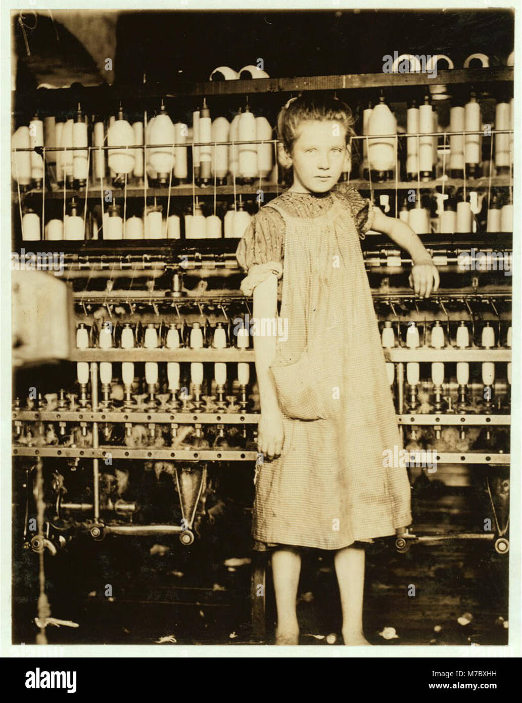 Addie Card, 12 years. Spinner in North Pormal (i.e., Pownal) Cotton Mill. Vt. Girls in mill say she is ten years. She admitted to me she was twelve; that she started during school vacation LOC cph.3a20286 Stock Photo