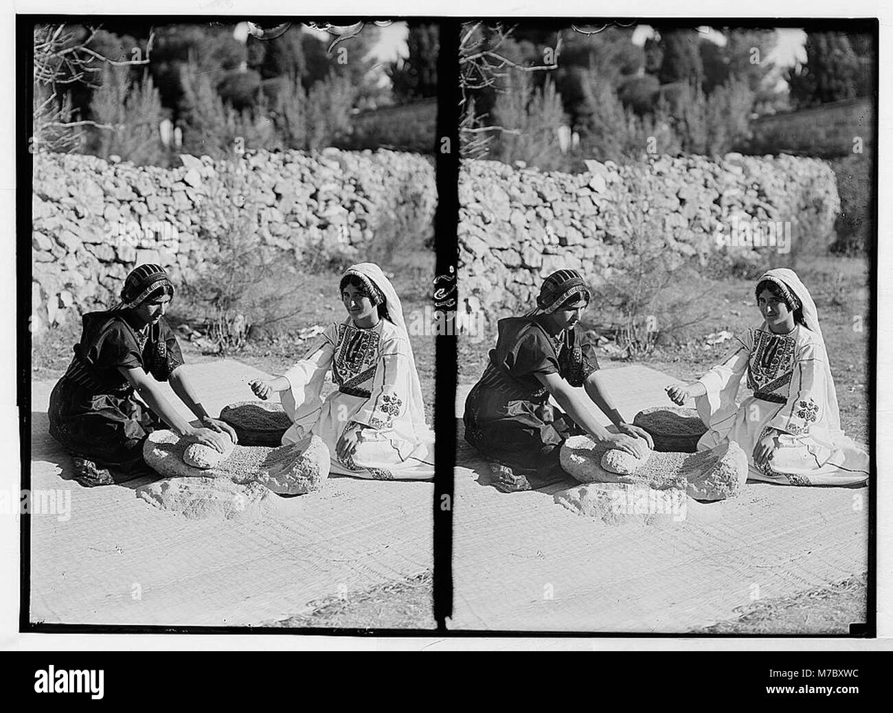 Agriculture, etc. Primitive methods of rubbing and grinding wheat. A large 'Grain rubber.' Process demonstrated by two peasant girls LOC matpc.02974 Stock Photo