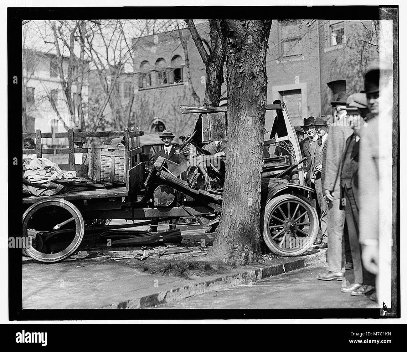 This image shows the aftermath of an auto wreck, capturing the damaged ...