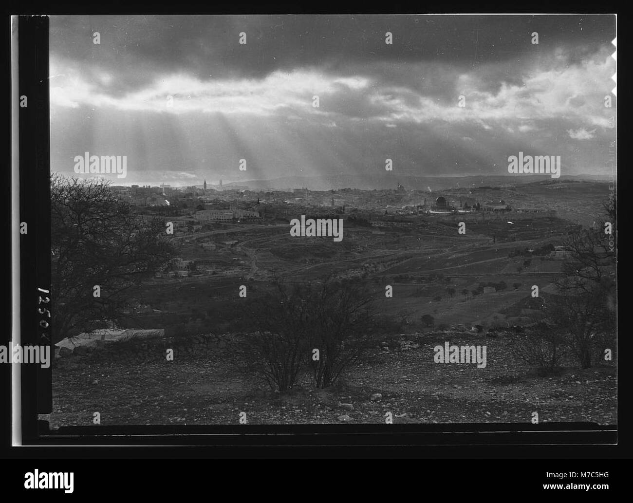 A photograph of sun rays shining over Jerusalem, taken from Mount Scopus in the late afternoon of February 6, 1942, capturing the city's ancient landscape. Stock Photo