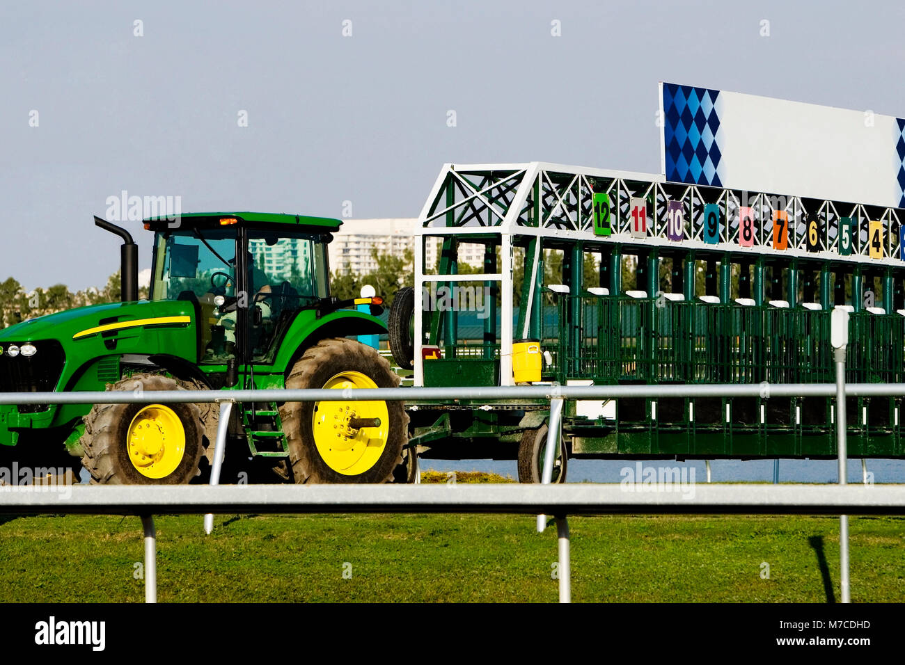 Tractor and empty starting gates at the horseracing track Stock Photo