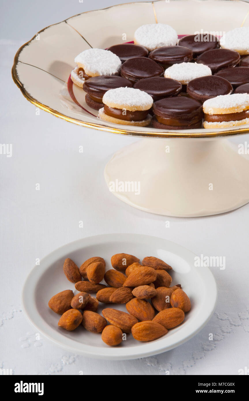 Chocolate cream cookies served with almonds Stock Photo