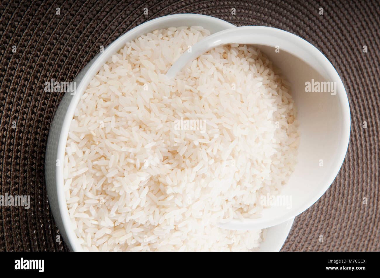 Uncooked rice in bowls hi-res stock photography and images - Alamy
