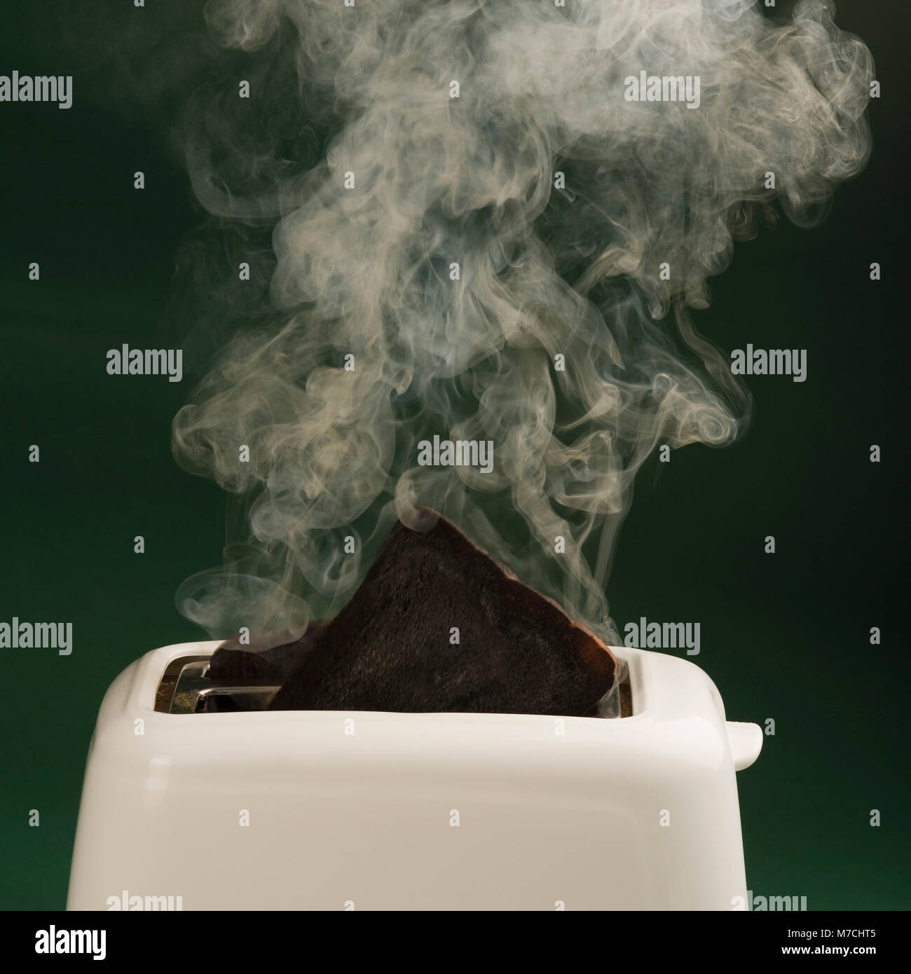 Smoke emerging from a burnt toast in toaster Stock Photo Alamy