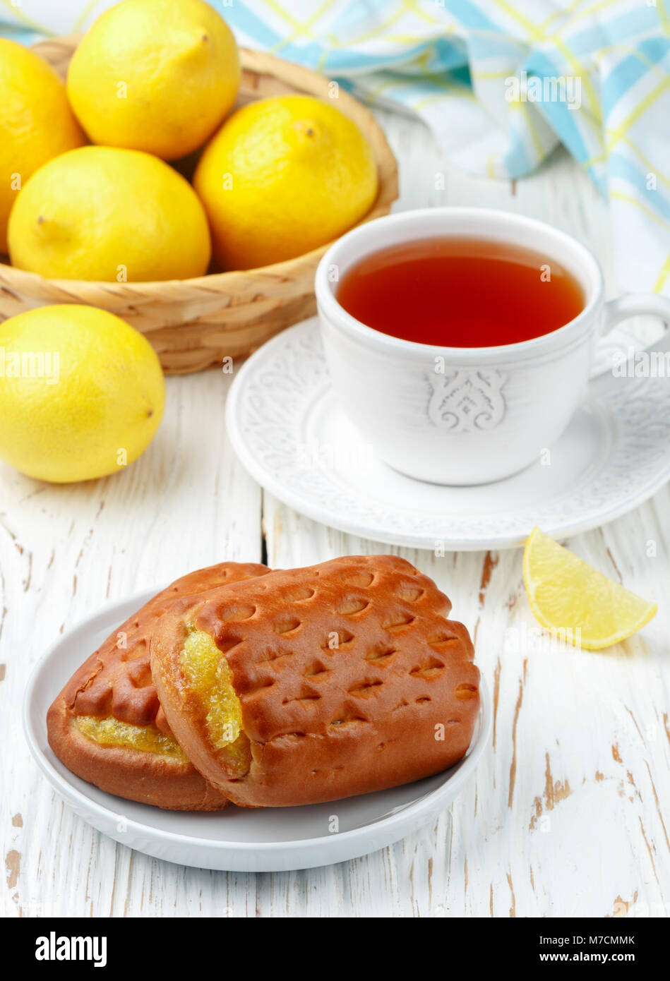 Traditionall Breakfast. Fresh homemade cakes with lemon and tea. Rustic style. Selective focus Stock Photo