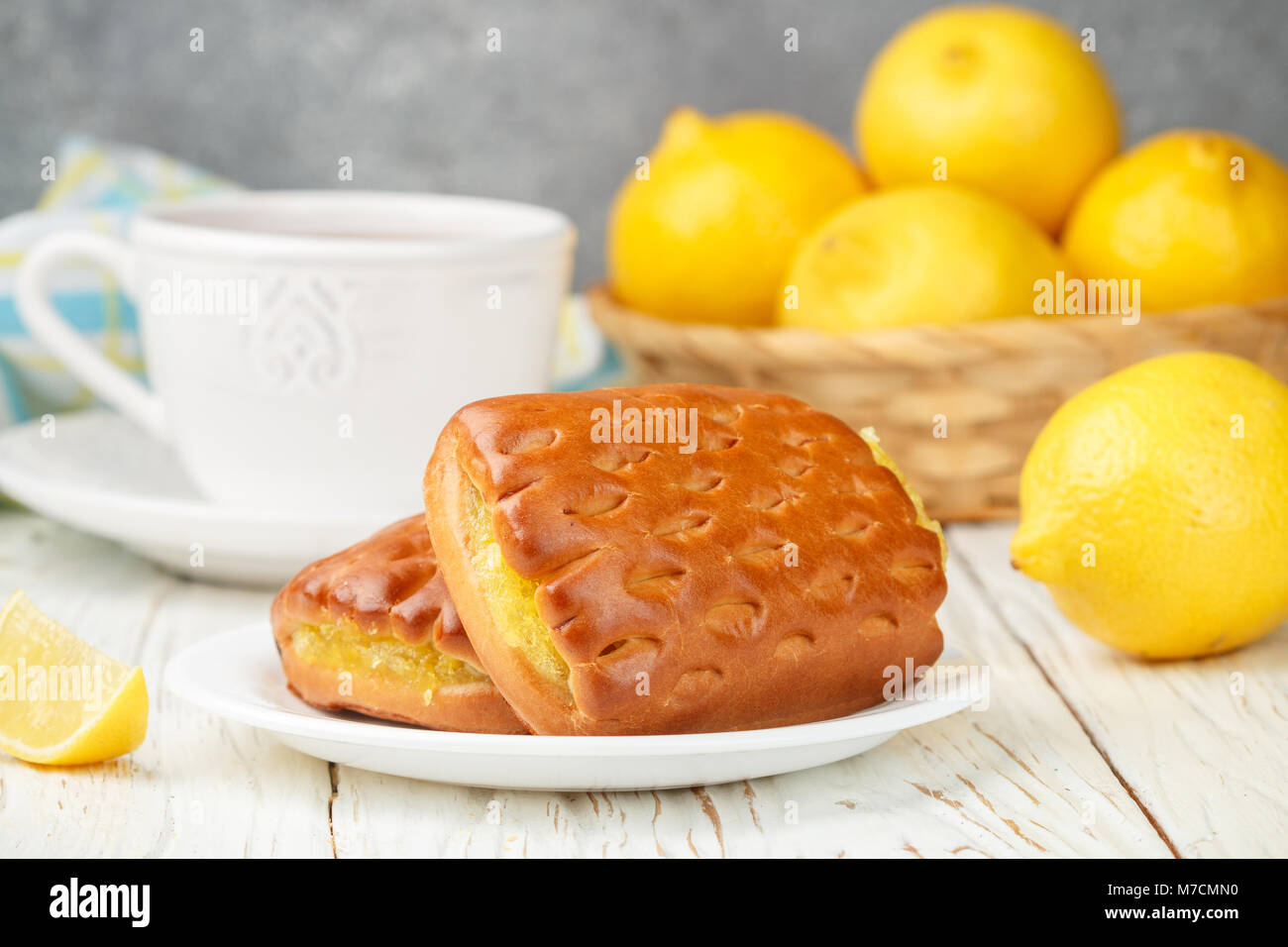 Traditionall Breakfast. Fresh homemade cakes with lemon and tea. Rustic style. Selective focus Stock Photo