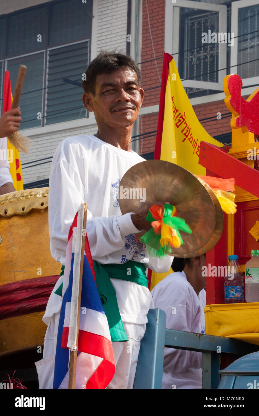 Man playing cymbals in a parade during the Nine Emperor Gods festival ...