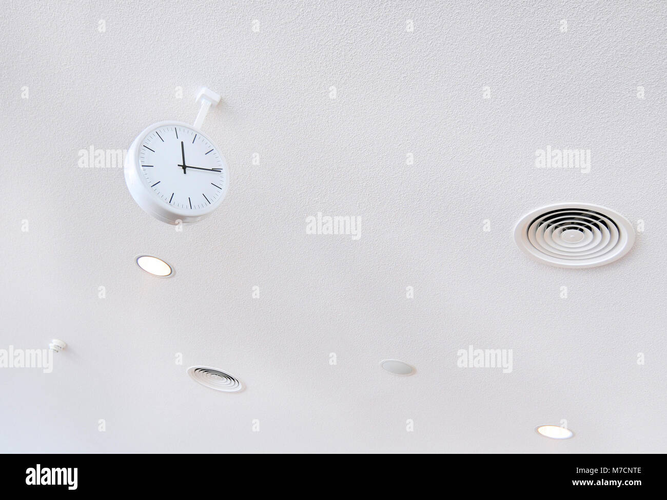 white clock on white futuristic background close-up Stock Photo