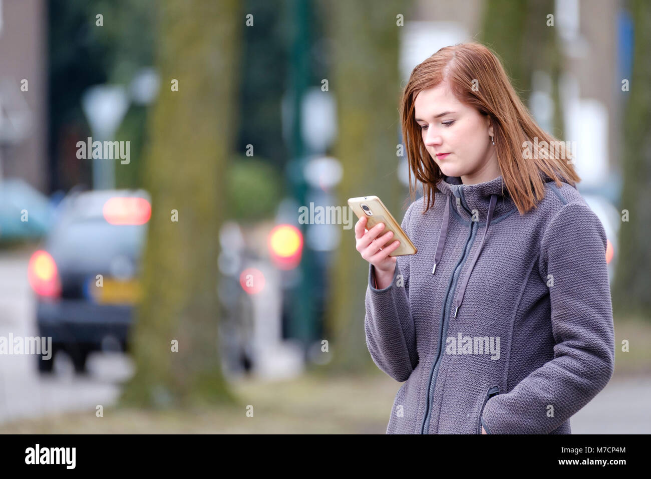 young woman checked her cell phone for new messages outdoors Stock Photo