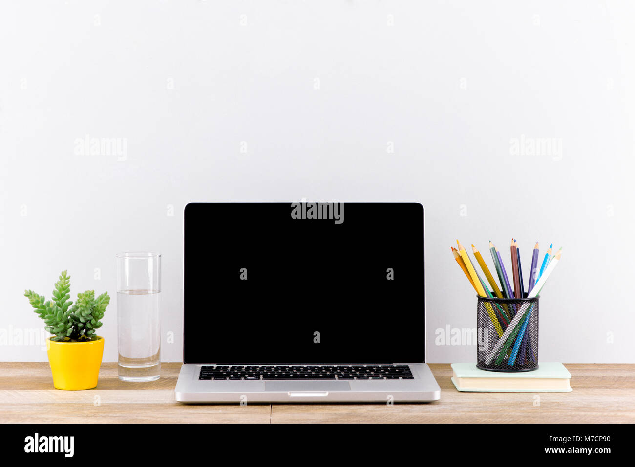 Laptop computer white blank screen on work table front view Stock Photo ...