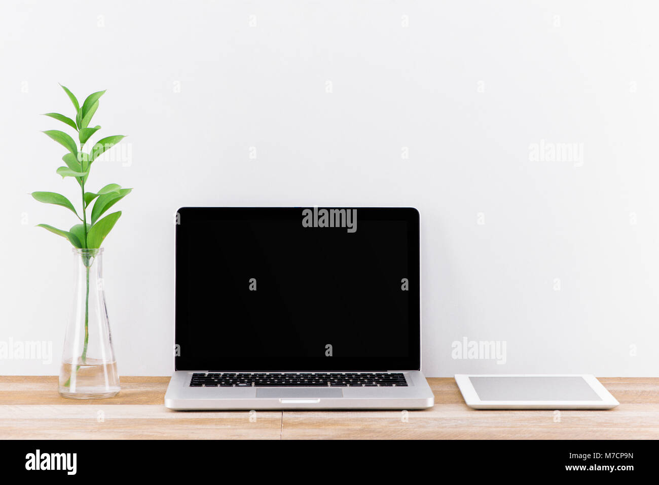 Laptop computer white blank screen on work table front view Stock Photo ...