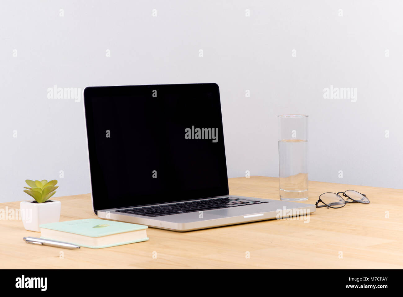 Laptop computer white blank screen on work table front view Stock Photo ...