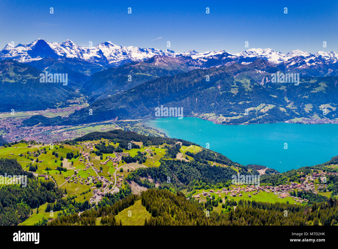 Aerial view of Lake Thun and Bernese Alps including Jungfrau, Eiger and Monch peaks from the top of Niederhorn in summer, Canton of Bern, Switzerland. Stock Photo