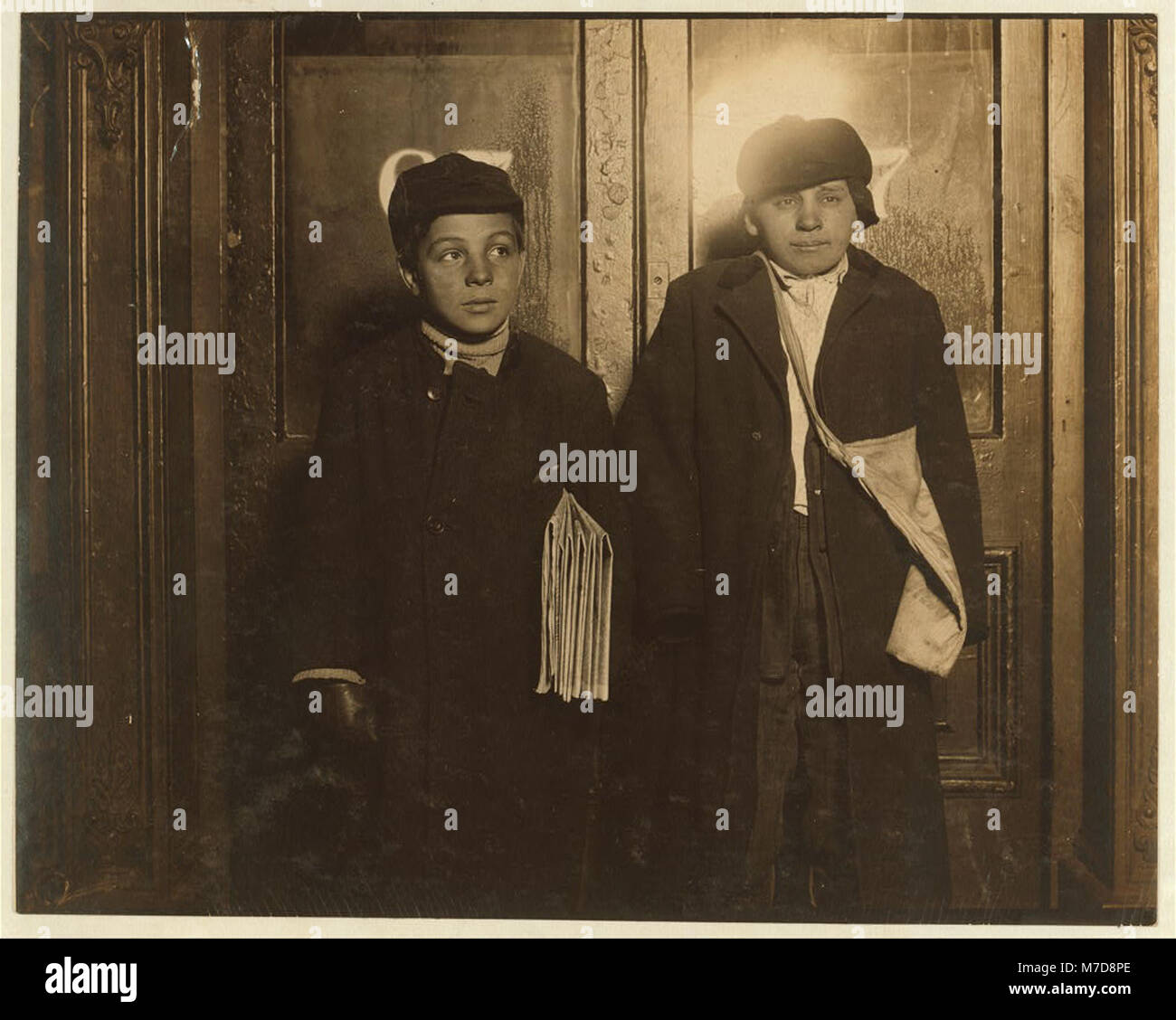 In a saloon doorway at 8:30 P.M. Left to right: George Cappello, 12 years  old, 270 Jay Street. Frank Laporter, 13 years old, 47 Third Avenue.  Abstract: Photographs from the records of