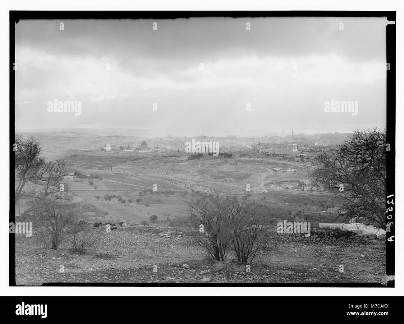 A photograph of Jerusalem bathed in sunlight, captured from Mount Scopus in the late afternoon of February 6, 1942. The image offers a view of the city under the soft glow of sun rays. Stock Photo