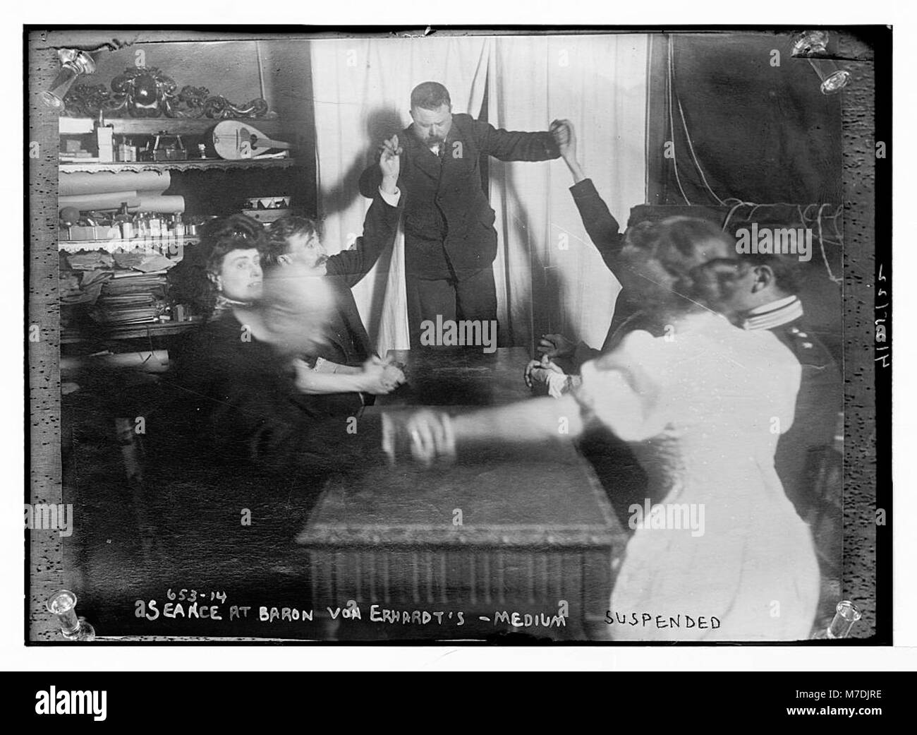 This image represents the concept of 'Medium,' possibly referring to the medium of communication or art in early 20th-century society. It emphasizes how mediums were used to communicate and portray messages in historical contexts. Stock Photo