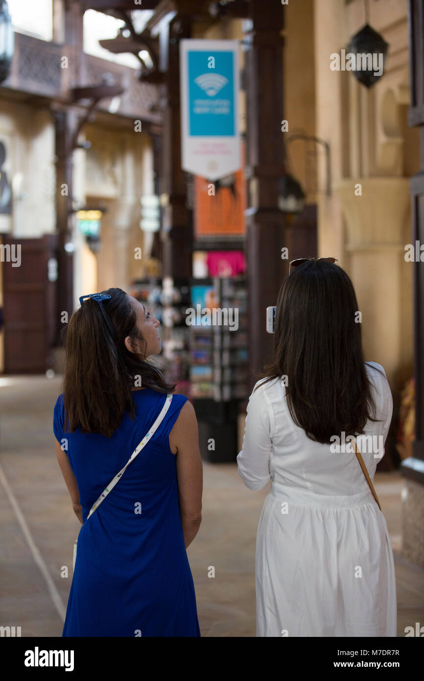 Rear view of female tourists inside Madinat Jumeirah souk Dubai UAE Stock Photo