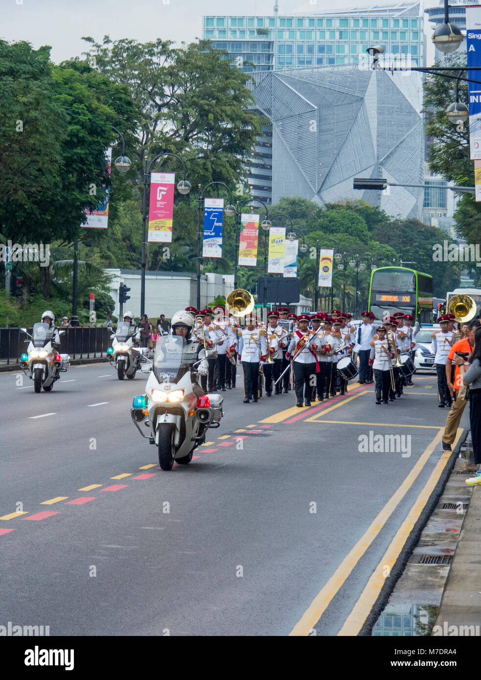 Brass band parading on Bras Basah Rd, Singapore. Stock Photo