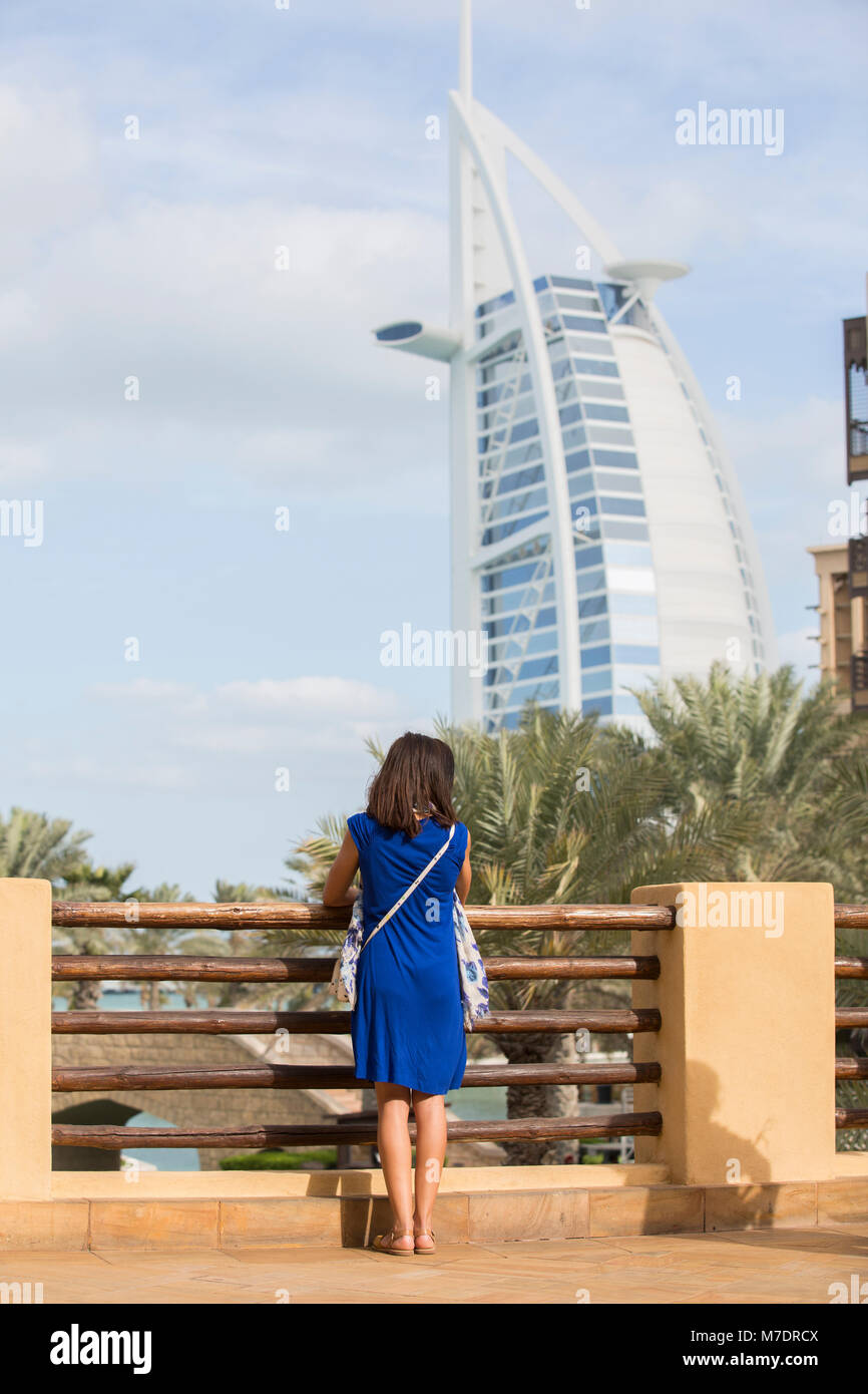 Female tourist looking at Burj Al Arab from Madinat Jumeirah Dubai UAE Stock Photo