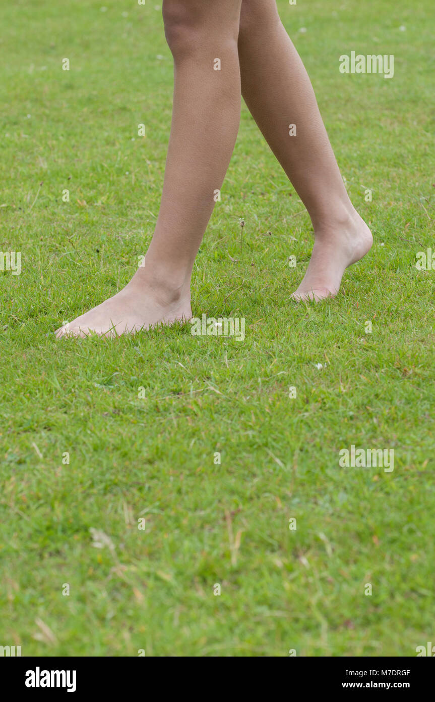 One woman walk barefoot grass hi-res stock photography and images - Alamy