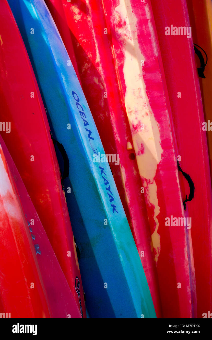 Row of colourful sea kayaks at Llangranog on the coast of Wales Stock Photo