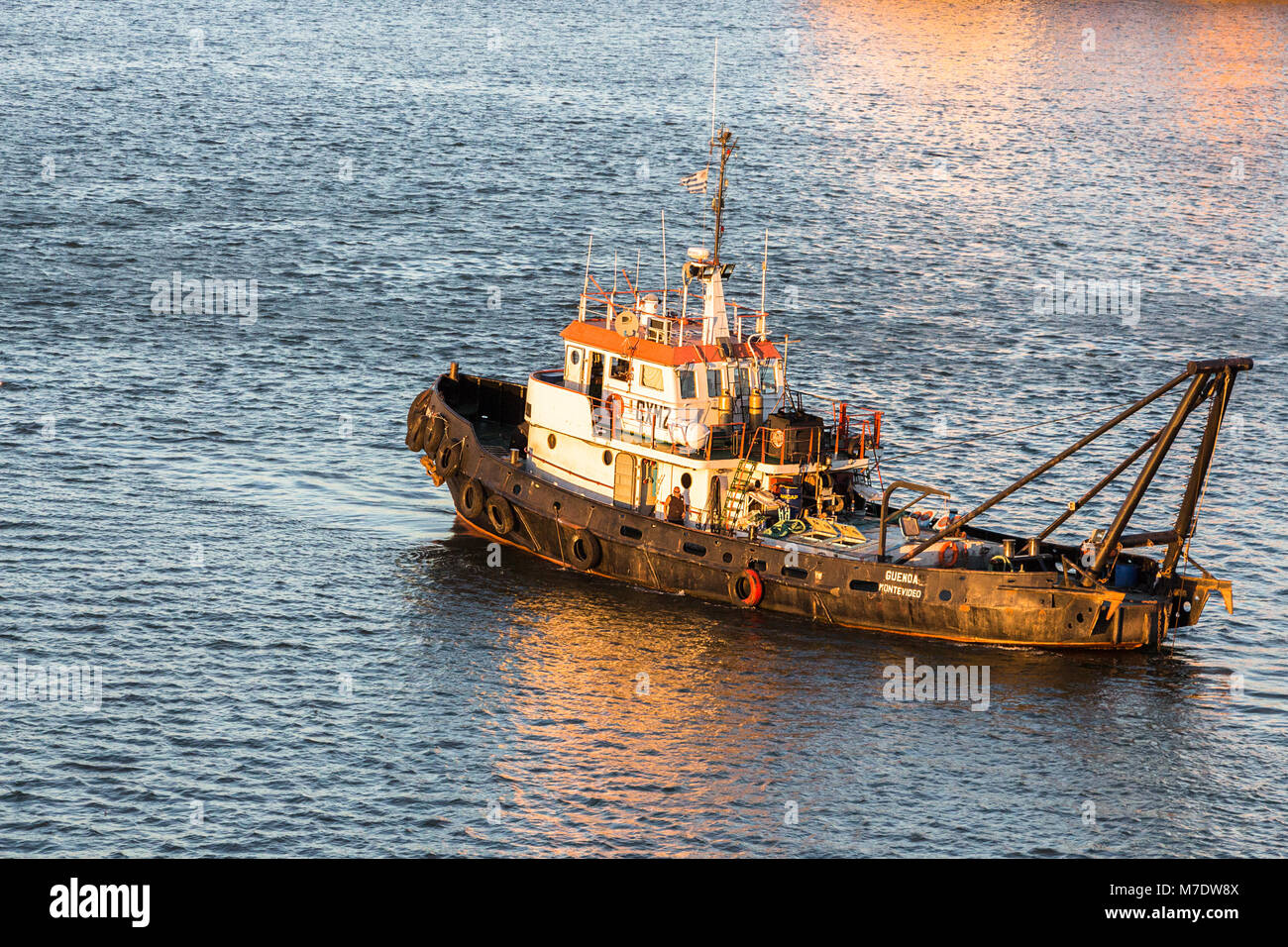 Montevideo, Uruguay - February 25th, 2018: A tugboat sailing around the Port of Montevideo at night in Uruguay, South America. Stock Photo