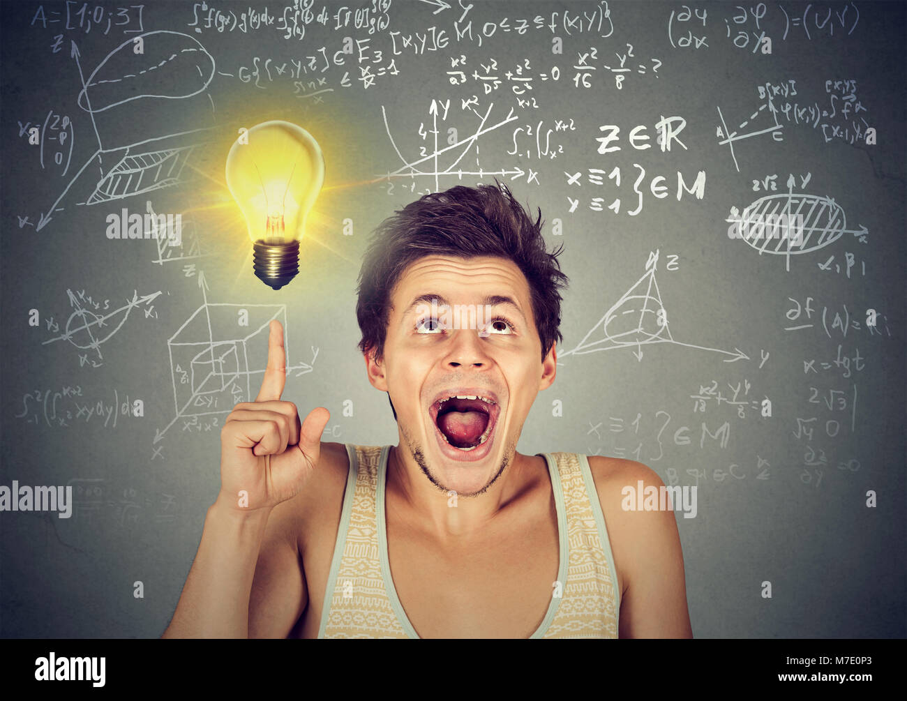 Young man pointing up enlightened with genius idea when studying science. Stock Photo