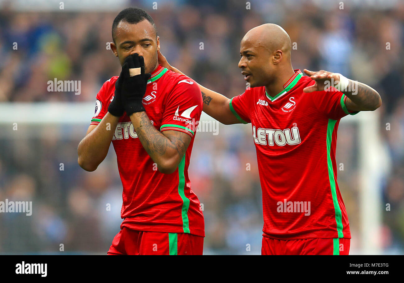Swansea City's Jordan Ayew is consoled by brother and team matesSwansea  City's Andre Ayew after being shown the red card during the Premier League  match at the John Smith's Stadium, Huddersfield Stock