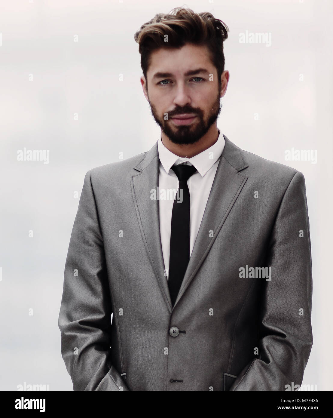 A young man in a gray suit Stock Photo - Alamy