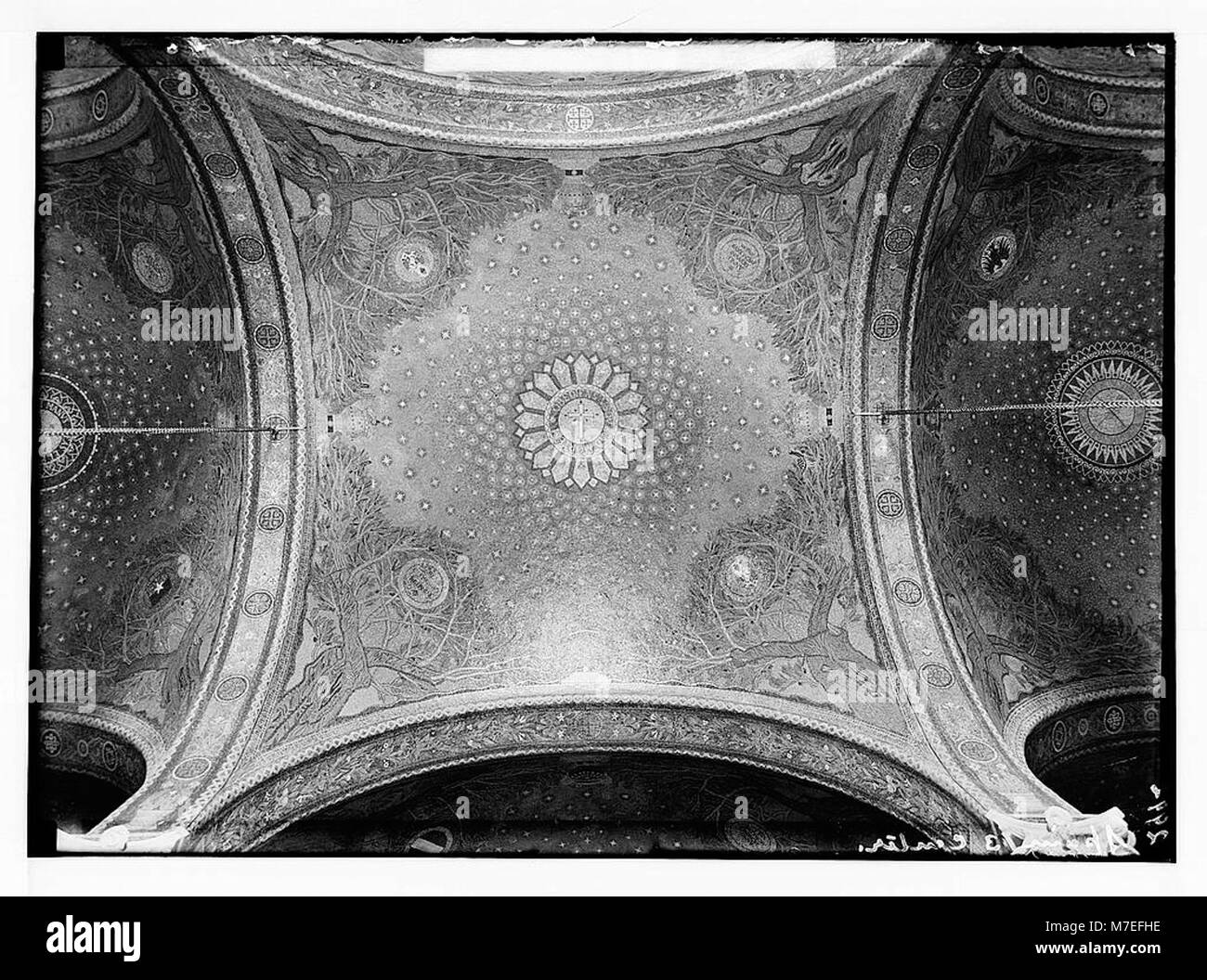 The Church of All Nations, also known as the Church of the Agony, features 12 mosaic domes donated by different countries. These mosaics depict religious themes and are significant for their artistic and historical value. The interior dome was a gift from Spain. Stock Photo