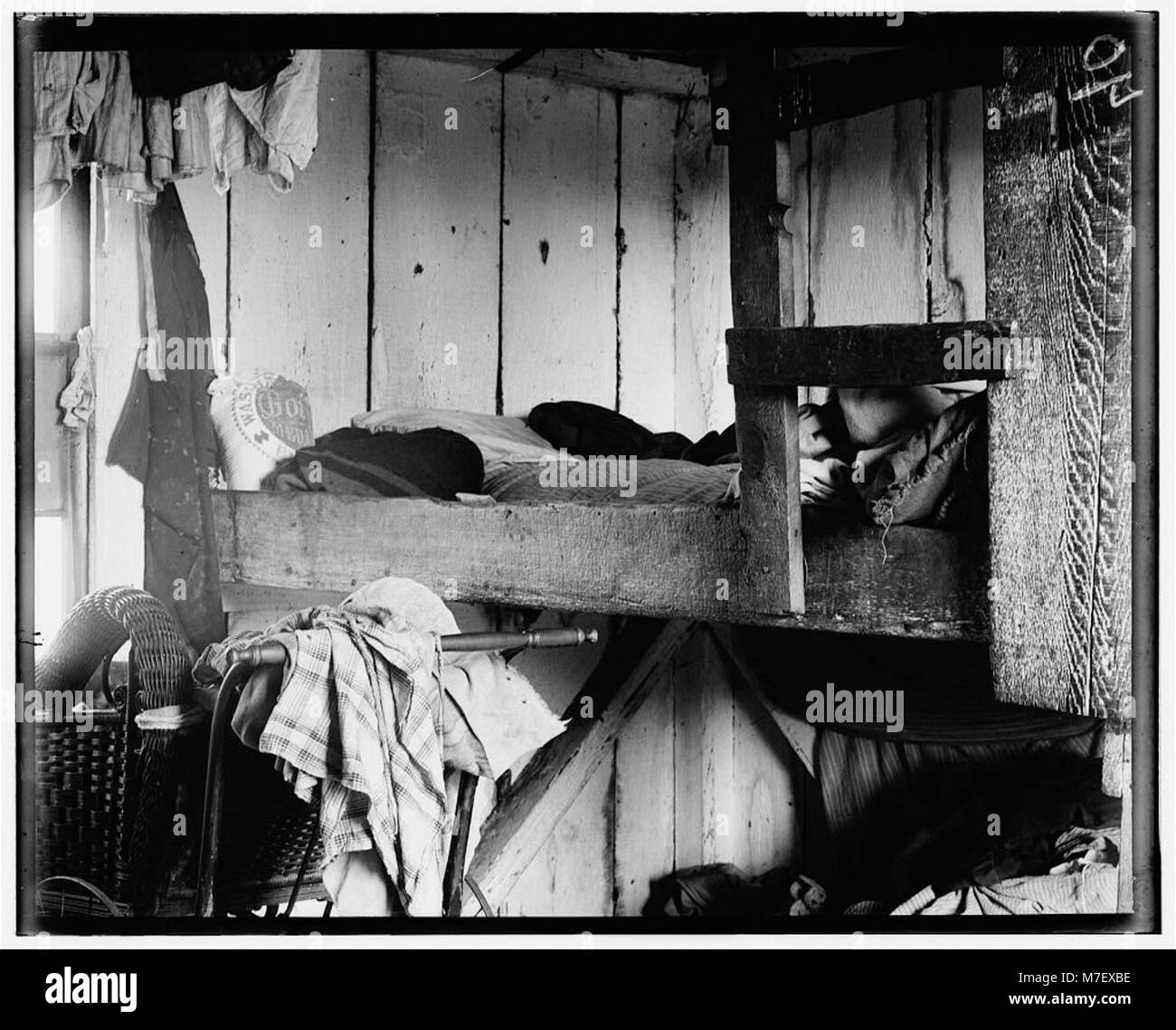 Small shack on Forsythe's Bog, occupied by De Marco family, 10 in the family living in this one room. Room is 10 ft. x 11 ft. X 5 1-2 ft. high and gable attic above. (See family picking LOC nclc.05309 Stock Photo