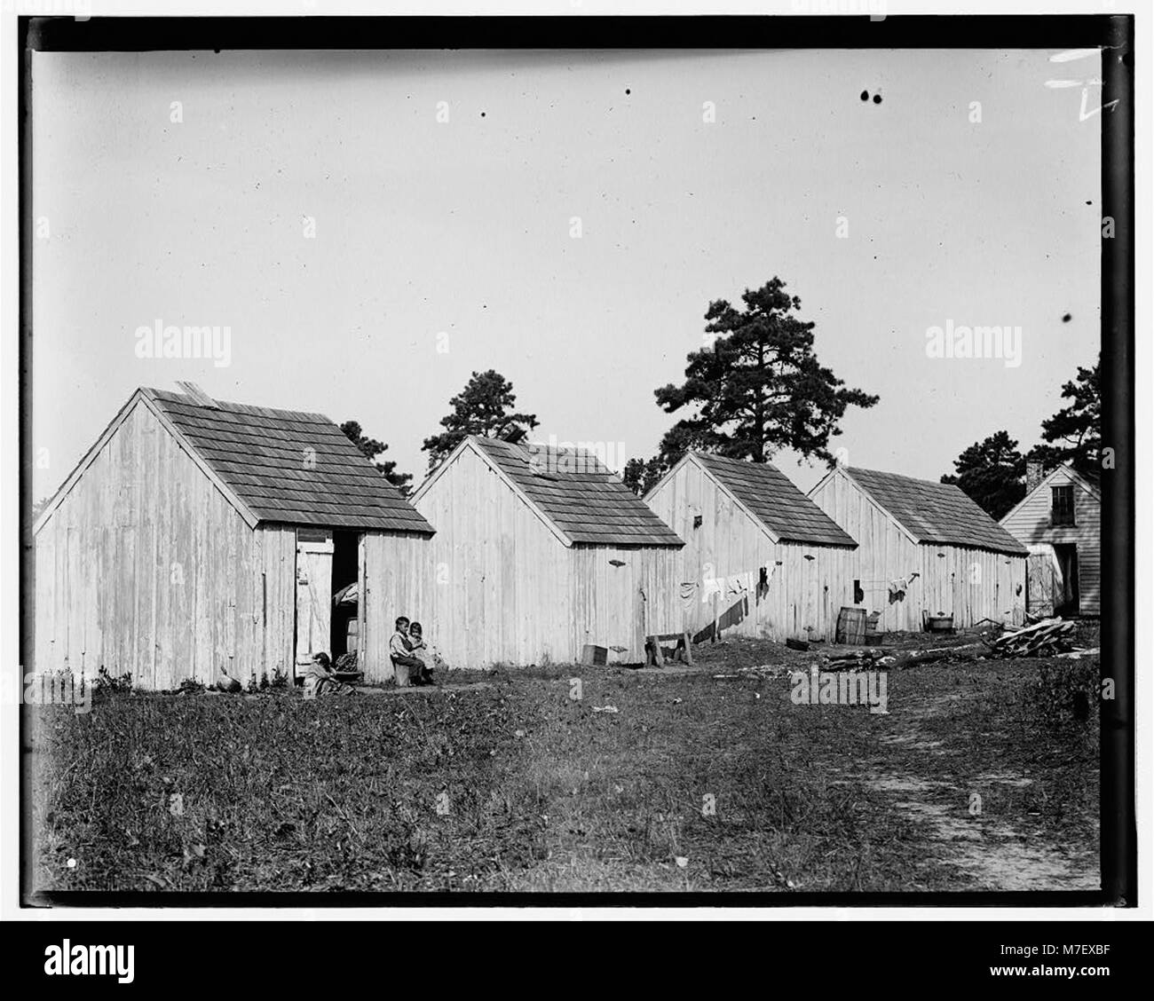 Small shack on Forsythe's Bog, occupied by De Marco family, 10 in the family living in this one room. Room is 10 ft. x 11 ft. x 5 1-2 ft. high and gable attic above. Wooden toilets near at LOC nclc.05310 Stock Photo