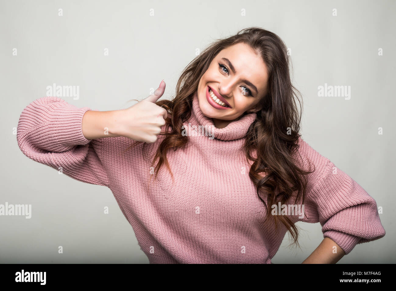 Young happy cheerful woman showing thumb up Stock Photo - Alamy